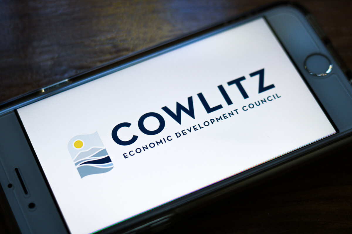 Photo of a phone displaying a logo for Cowlitz Economic Development Council