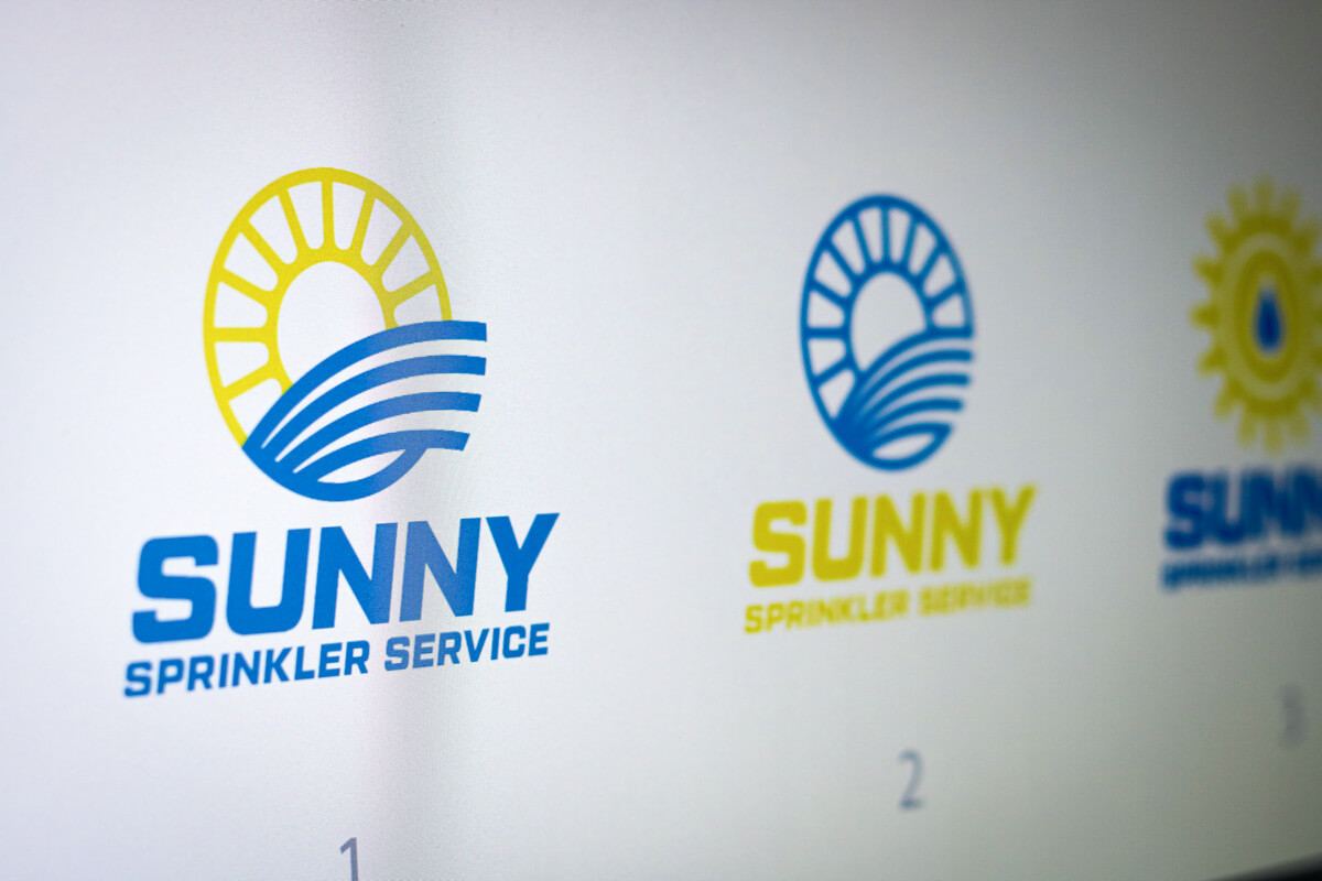 Photo of various logo concepts for a Sprinkler company called Sunny Sprinkler Service